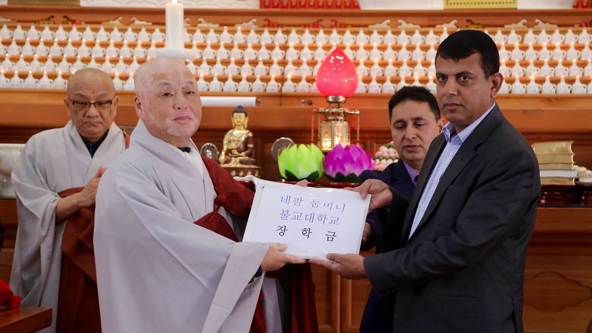 Dr. Tilak Ram Acharya receiving scholarship at Korean Buddhist temple ceremony 2017