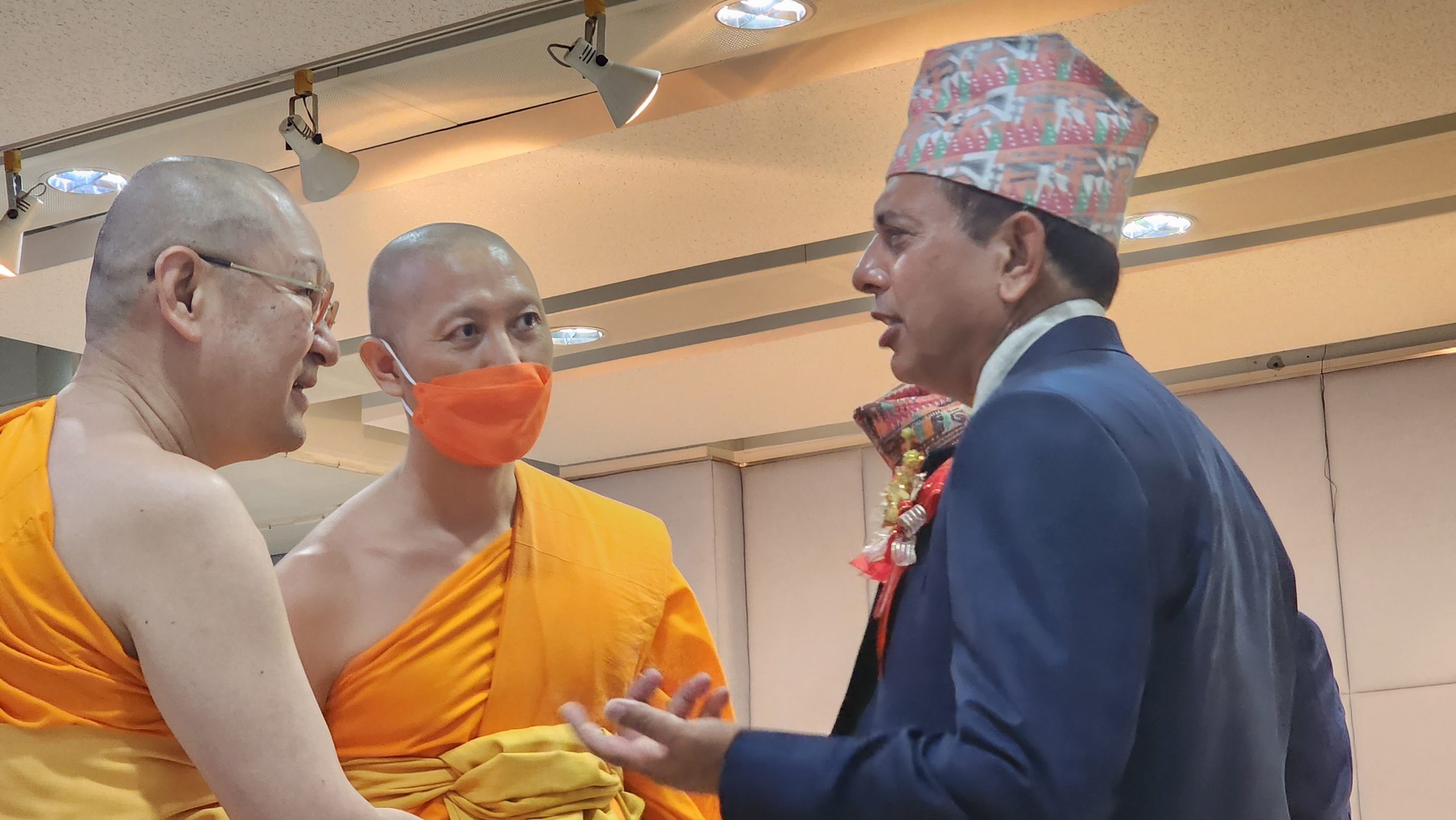 Dr. Tilak Ram Acharya in discussion with Buddhist monks at international conference April 2023