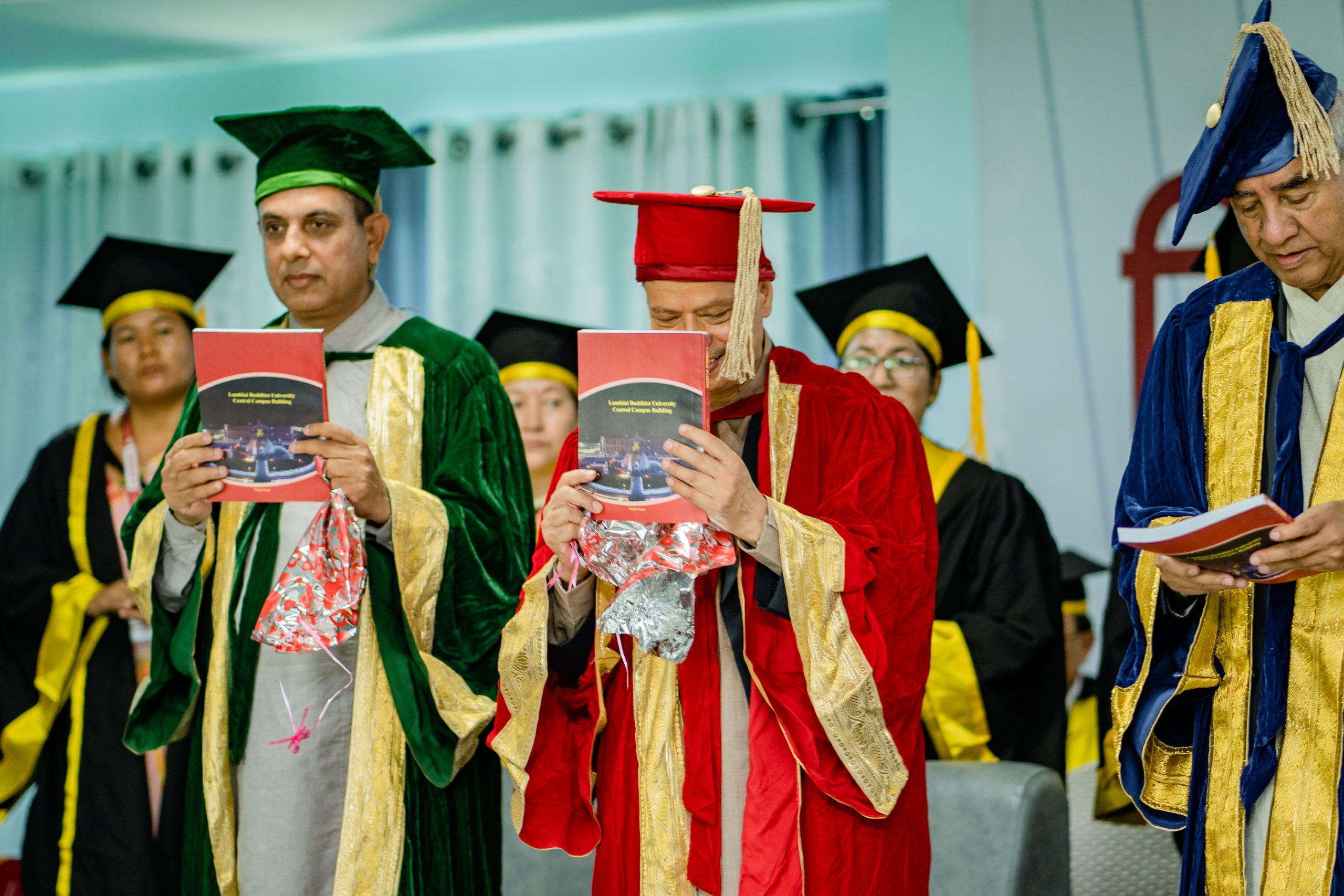 Academic procession reading programme booklet at Lumbini Buddhist University convocation Nepal