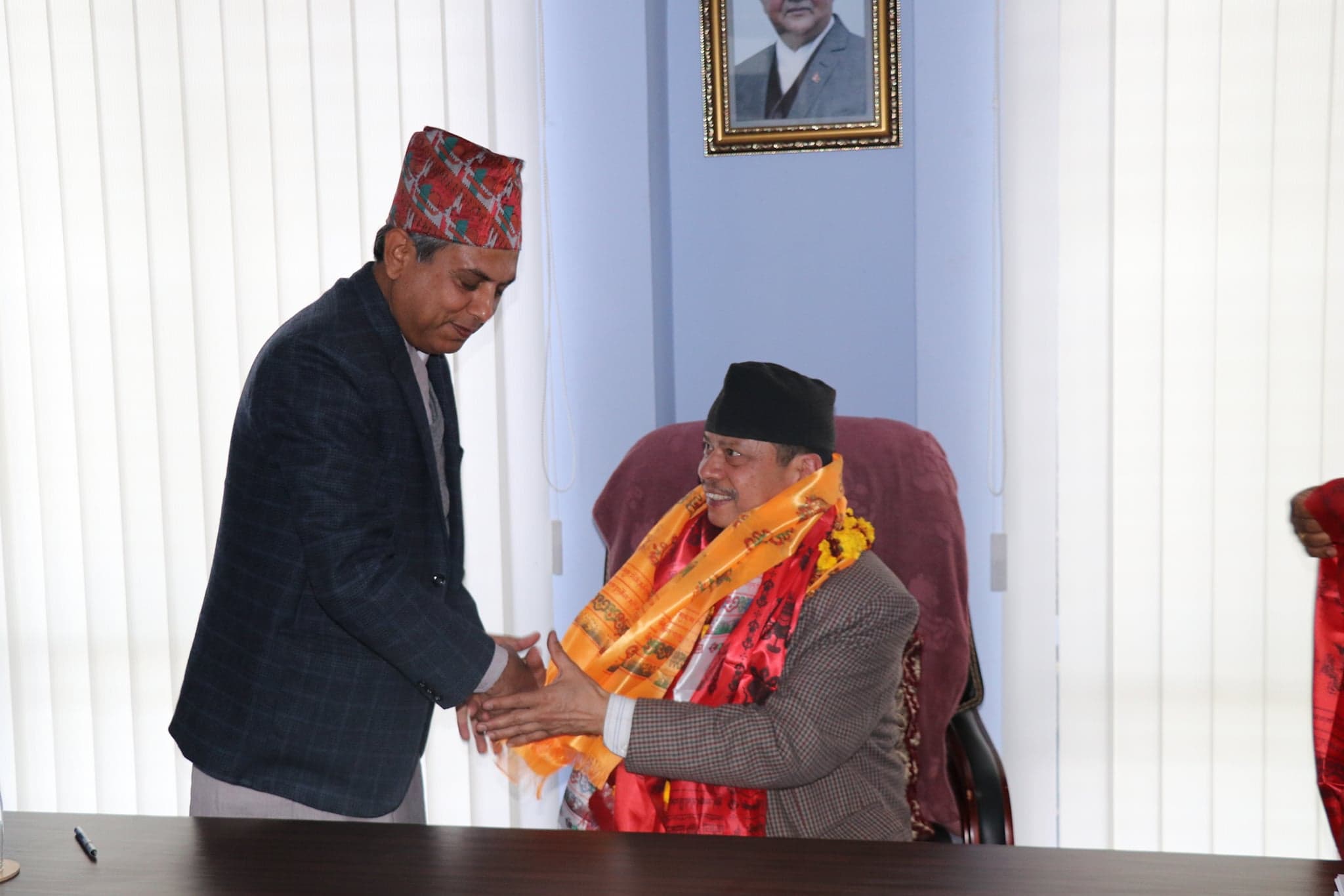 Dr. Tilak Ram Acharya receiving garland felicitation from Vice Chancellor Lumbini Buddhist University